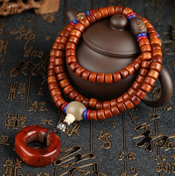 Tibetan yak bone bracelet, multi-strand bone beads, retro barrel bead jewelry, ethnic cultural gift, handmade Tibetan bracelet, spiritual protection jewelry, authentic yak bone beads, Himalayan traditional art, unisex cultural accessory, meditation bracelet, Tibetan craft souvenir, ethical bone jewelry, vintage style bracelet, red and blue accent beads, symbolic pendant design, cultural artifact gift, wearable ethnic art, Tibetan heritage jewelry, hand-strung bone beads, spiritual grounding accessory.