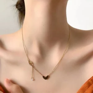 Gold-toned love heart necklace, titanium steel women's jewelry, double-sided pendant necklace, fade-proof adjustable chain, light luxury accessory, minimalist collarbone chain, hypoallergenic necklace, fashionable gift idea, versatile daily wear, sustainable materials, affordable elegance, artisan crafted, positive energy jewelry, modern feminine style, special occasion gift, holistic wellness accessory, cultural inspired design, elegant packaging.