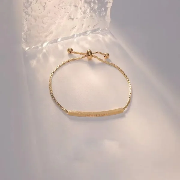 Titanium steel adjustable bracelet, letter initial curved tube jewelry, fade-proof sliding knot chain, 22cm women's bracelet, light luxury minimalist accessory, JIN BAI ZHENG brand, hypoallergenic jewelry, personalized engraving, brushed-gold finish, versatile daily wear, sustainable materials, affordable luxury, artisan crafted, positive energy accessory, modern feminine style, special occasion gift, holistic wellness jewelry, cultural inspired design, elegant packaging.