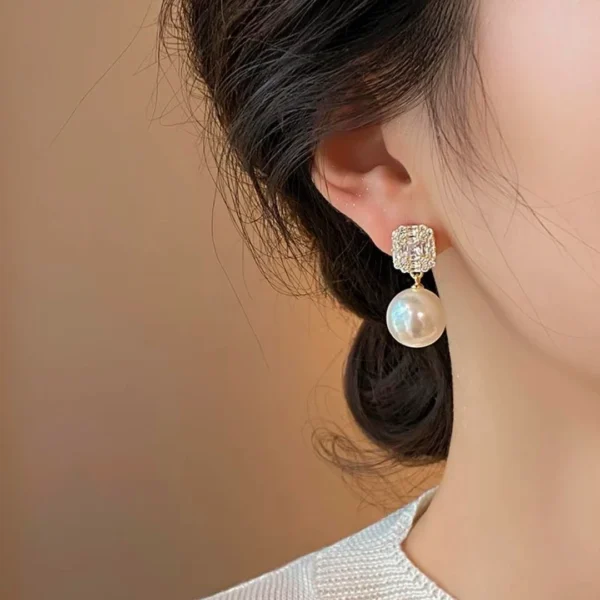 Elegant model wearing JIN BAI ZHENG Zircon and Pearl Earrings