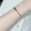 Titanium steel adjustable bracelet, letter initial curved tube jewelry, fade-proof sliding knot chain, 22cm women's bracelet, light luxury minimalist accessory, JIN BAI ZHENG brand, hypoallergenic jewelry, personalized engraving, brushed-gold finish, versatile daily wear, sustainable materials, affordable luxury, artisan crafted, positive energy accessory, modern feminine style, special occasion gift, holistic wellness jewelry, cultural inspired design, elegant packaging.