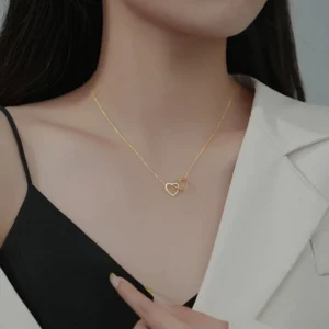 Close-up of woman wearing Interlocking Heart Necklace with black top