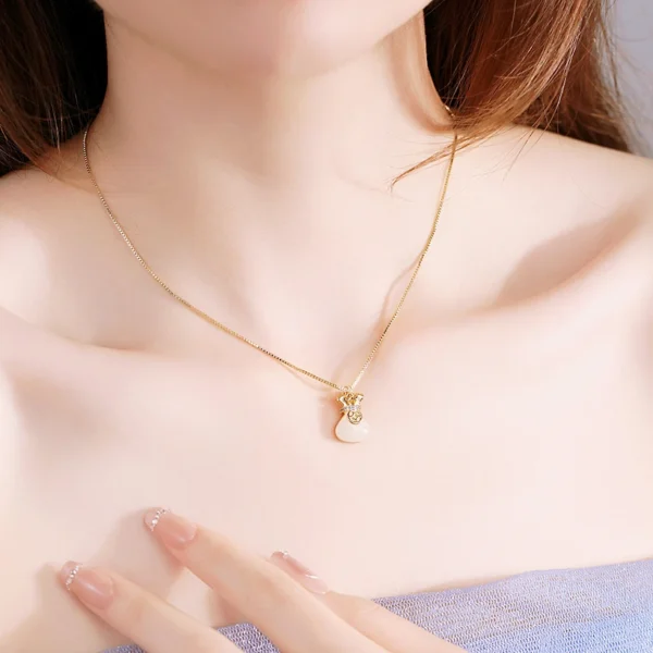 Titanium steel fortune bag necklace, everlasting color jewelry, K-gold plated lock chain, blessing-filled pendant, JIN BAI ZHENG brand, hypoallergenic collarbone necklace, adjustable chain necklace, pearl accent jewelry, light luxury accessory, symbolic gift for her, tarnish-proof necklace, versatile daily wear, cultural inspired design, affordable luxury, sustainable materials, artisan crafted, modern feminine style, positive energy accessory, holistic wellness jewelry, special occasion gift.