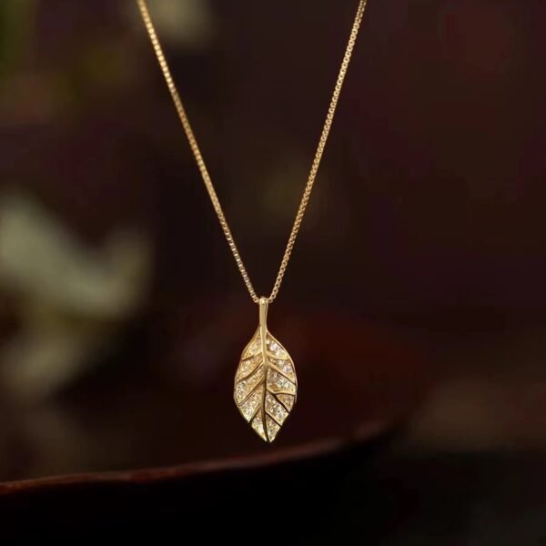 Titanium steel leaf necklace, synthetic zircon pendant, niche style jewelry, light luxury collarbone chain, adjustable necklace for women, hypoallergenic fashion accessory, versatile daily wear, sweet and elegant gift, sustainable materials, affordable luxury, artisan crafted, positive energy accessory, modern feminine style, cultural inspired design, holistic wellness jewelry, special occasion gift, minimalist jewelry, layering piece, elegant packaging.