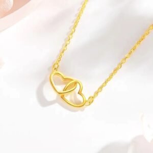JIN BAI ZHENG Gold Interlocking Heart Necklace on light background