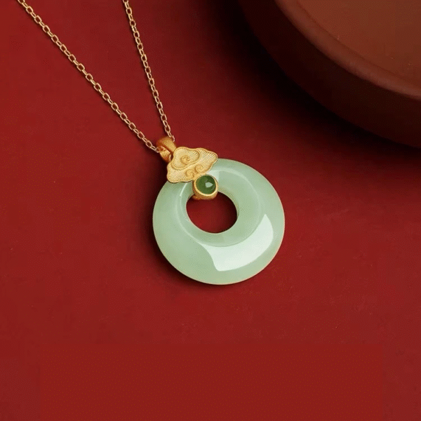 S925 Sterling Silver Lucky Coin Necklace with Light Green Jade on red dish