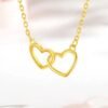 Close-up of Golden Interlocking Heart Pendant on chain