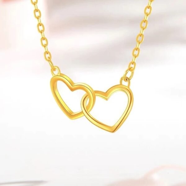 Close-up of Golden Interlocking Heart Pendant on chain