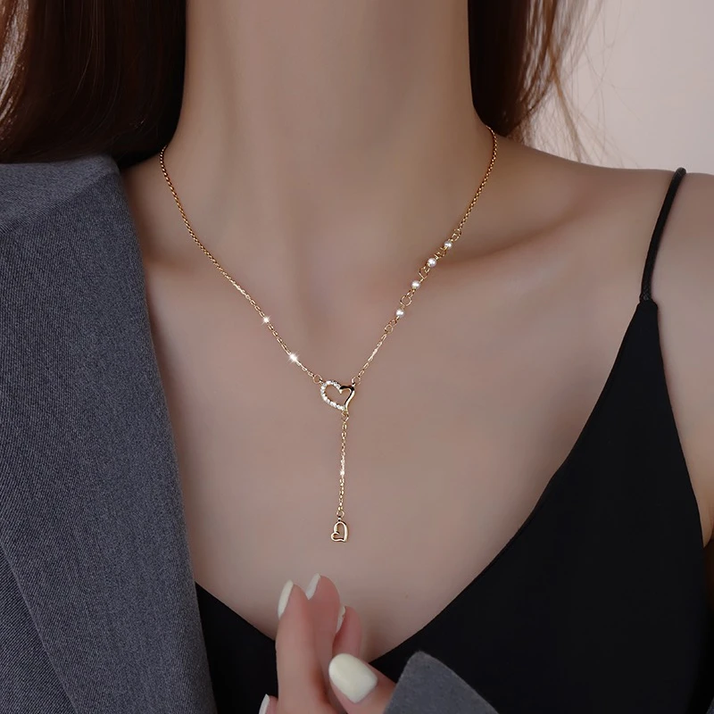 Titanium steel double heart necklace, interlocking chain design, tassel pendant jewelry, adjustable lock-neck chain, JIN BAI ZHENG brand, hypoallergenic women's necklace, romantic gift idea, small-batch design jewelry, fade-proof accessory, versatile daily wear, sustainable materials, affordable luxury, artisan crafted, positive energy accessory, modern feminine style, special occasion gift, holistic wellness jewelry, cultural inspired design, elegant packaging, heartbeat-themed jewelry.