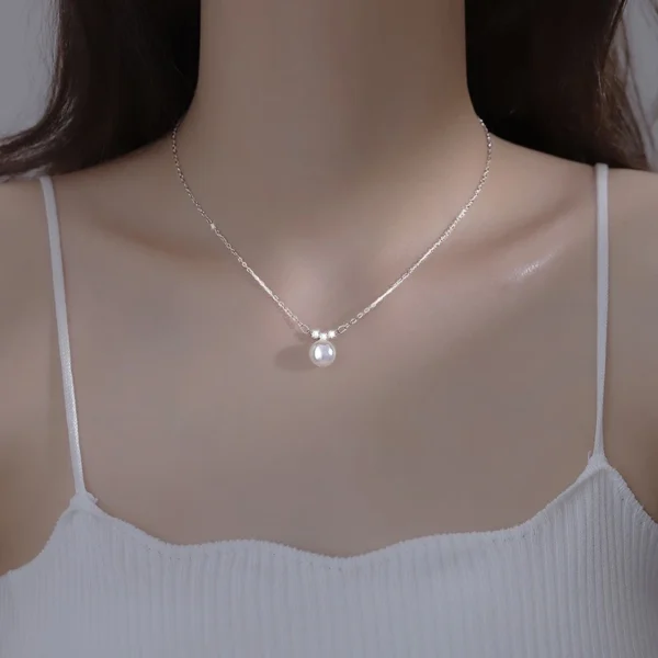 Woman wearing Titanium Steel Pearl Bead Necklace with white top