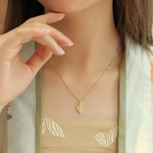 Titanium steel leaf necklace, synthetic zircon pendant, niche style jewelry, light luxury collarbone chain, adjustable necklace for women, hypoallergenic fashion accessory, versatile daily wear, sweet and elegant gift, sustainable materials, affordable luxury, artisan crafted, positive energy accessory, modern feminine style, cultural inspired design, holistic wellness jewelry, special occasion gift, minimalist jewelry, layering piece, elegant packaging.