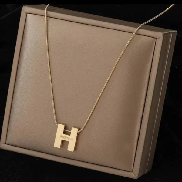 Titanium steel initial necklace, "H" letter pendant jewelry, fade-proof minimalist chain, adjustable collarbone necklace, light luxury women's accessory, small-batch jewelry, hypoallergenic necklace, versatile daily wear, personalized gift idea, sustainable materials, affordable luxury, artisan crafted, modern feminine style, positive energy accessory, cultural inspired design, special occasion gift, holistic wellness jewelry, elegant packaging, trendy fashion accessory, durable titanium jewelry.