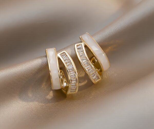 S925 sterling silver earrings, women's stud jewelry, minimalist hoop earrings, dainty silver hoops, crystal accent earrings, everyday elegant jewelry, polished silver studs, brushed silver earrings, two-tone jewelry design, small hoop earrings for women, delicate silver jewelry, trendy stud earrings, layered earring sets, silver jewelry gifts, contemporary jewelry design, hypoallergenic earrings, lightweight stud earrings, luxury silver earrings, interlocking crescent earrings, pavé crystal earrings.