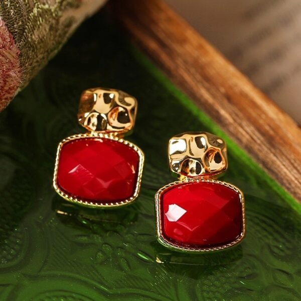 Square drop enamel earrings, original design earrings, glazed red stone jewelry, gold-toned earrings, hypoallergenic silver studs, women's fashion earrings, statement drop earrings, artisan ceramic earrings, luxury women's accessories, geometric drop earrings, handcrafted enamel jewelry, textured frame earrings, modern minimalist earrings, gift for her, unique designer earrings, red and gold earrings, lightweight drop earrings, everyday luxury jewelry, special occasion earrings, contemporary women's jewelry.