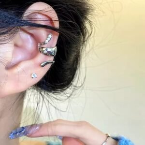 Silver serpent ear cuff, studless snake ear accessory, zirconia-adorned ear cuff, non-pierced ear jewelry, minimalist serpent design, adjustable ear cuff, hypoallergenic fashion jewelry, symbolic animal earwear, modern ear coil, lightweight ear cuff, day to night ear accessory, gift for trendsetters, contemporary ear jewelry, mystical animal motif, secure fit ear cuff, fashion-forward ear piece, versatile ear design, pain-free ear accessory, glamorous ear cuff, unique ear jewelry.