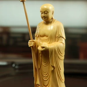 Boxwood Dizang Bodhisattva statue, hand-carved Buddhist altar ornament, 21cm standing Ksitigarbha, sustainable wood carving, detailed robe sculpture, lotus base statue, spiritual decor, traditional craftsmanship, eco-friendly religious art, meditation space centerpiece, cultural gift idea, serene Bodhisattva carving, home temple accessory, artisan woodwork, mindfulness symbol, ethical sourcing, Zen inspiration, collector’s spiritual art, compact altar statue, symbolic Buddhist gift.