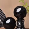 Obsidian ornament with carvings and traditional paint