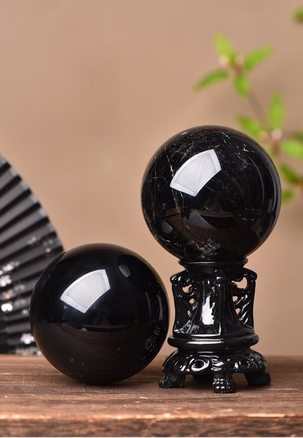 Obsidian ornament with carvings and traditional paint