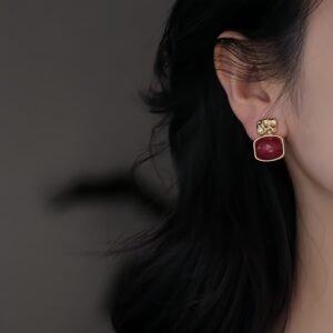 Square drop enamel earrings, original design earrings, glazed red stone jewelry, gold-toned earrings, hypoallergenic silver studs, women's fashion earrings, statement drop earrings, artisan ceramic earrings, luxury women's accessories, geometric drop earrings, handcrafted enamel jewelry, textured frame earrings, modern minimalist earrings, gift for her, unique designer earrings, red and gold earrings, lightweight drop earrings, everyday luxury jewelry, special occasion earrings, contemporary women's jewelry.