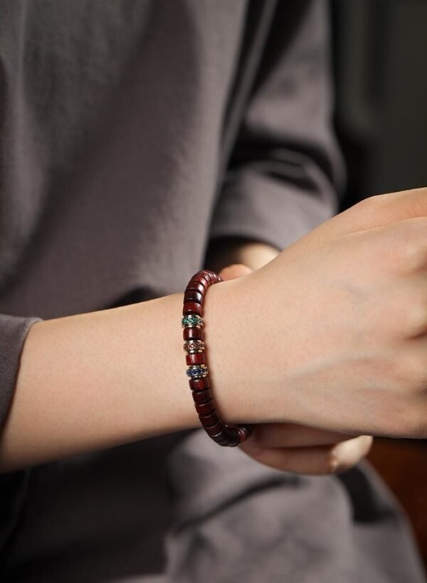 Red sandalwood prayer bracelet, straight-cut tablet beads, Buddhist meditation bracelet, unisex sandalwood jewelry, Indian red sandalwood beads, wooden prayer beads, minimalist spiritual wear, Zen meditation accessories, natural fragrance bracelet, sustainable wood jewelry, handmade mala bracelet, Om symbol bracelet, turquoise accent bead, aromatic sandalwood beads, classic Buddhist craft, lightweight prayer beads, cultural collectible jewelry, adjustable meditation bracelet, daily mindfulness accessory.