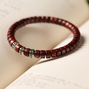 Red sandalwood prayer bracelet, straight-cut tablet beads, Buddhist meditation bracelet, unisex sandalwood jewelry, Indian red sandalwood beads, wooden prayer beads, minimalist spiritual wear, Zen meditation accessories, natural fragrance bracelet, sustainable wood jewelry, handmade mala bracelet, Om symbol bracelet, turquoise accent bead, aromatic sandalwood beads, classic Buddhist craft, lightweight prayer beads, cultural collectible jewelry, adjustable meditation bracelet, daily mindfulness accessory.