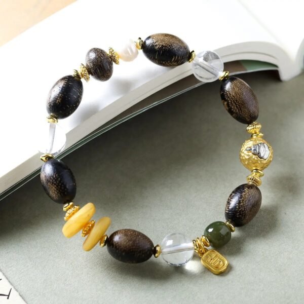10mm white crystal agarwood bracelet, natural crystal and wood jewelry, purifying energy bracelet, meditation balance accessory, spiritual grounding jewelry, alternating bead design, sustainable spiritual wear, calming aroma beads, holistic healing bracelet, handcrafted mala alternative, positive energy flow jewelry, earthy fragrance beads, daily mindfulness accessory, ethical sourcing bracelet, crystal purification properties, agarwood calming benefits, gender-neutral spiritual gift, eco-friendly materials, artisan crafted bracelet, versatile meditation tool.