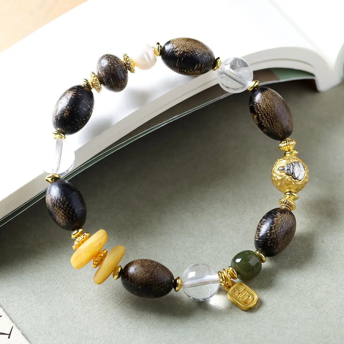 10mm white crystal agarwood bracelet, natural crystal and wood jewelry, purifying energy bracelet, meditation balance accessory, spiritual grounding jewelry, alternating bead design, sustainable spiritual wear, calming aroma beads, holistic healing bracelet, handcrafted mala alternative, positive energy flow jewelry, earthy fragrance beads, daily mindfulness accessory, ethical sourcing bracelet, crystal purification properties, agarwood calming benefits, gender-neutral spiritual gift, eco-friendly materials, artisan crafted bracelet, versatile meditation tool.