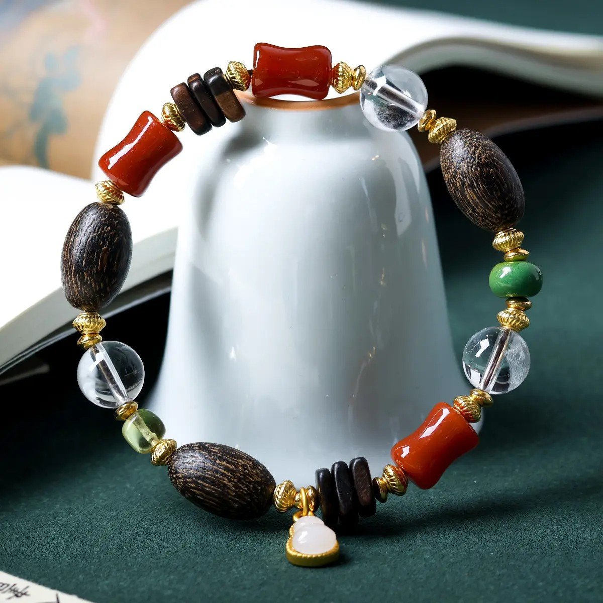 10mm white crystal bracelet, bug-hole agarwood jewelry, natural chénxiāng bracelet, spiritual healing bracelet, red agate and jade accessories, gold-accented beaded bracelet, handmade crystal agarwood combo, meditation energy jewelry, elastic stretch bracelet, white jade heart charm, holistic balance jewelry, Eastern-inspired accessories, aromatic agarwood beads, protection and clarity bracelet, luxury spiritual gift, natural resin-rich agarwood, artisan beaded design, daily mindfulness jewelry, ethical sourcing bracelet, multidimensional beaded bracelet.
