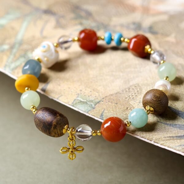 8mm wooden bead bracelet, gemstone evil-eye jewelry, spiritual protection bracelet, natural wood and gemstone accessory, positive energy jewelry, evil-eye charm bracelet, carnelian amazonite pearls, grounding wood beads, handmade spiritual bracelet, symbolic jewelry gift, daily mindfulness accessory, elastic-free knotting design, versatile layering bracelet, ethical materials jewelry, holistic wellness accessory, cultural symbolism bracelet, minimalist earthy jewelry, artisan crafted bracelet, negative energy ward, modern bohemian style.