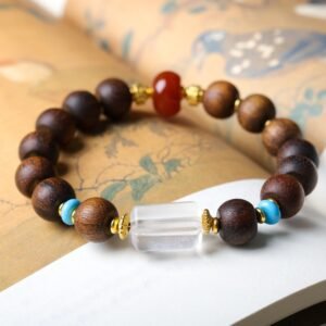 10mm Yellow Qi Nan agarwood bracelet, lantern bead jewelry, gemstone accent bracelet, spiritual meditation bracelet, handmade agarwood mala, red agate turquoise crystal beads, gold-toned spacer design, cultural symbolic jewelry, aromatic therapy bracelet, ethical agarwood sourcing, elastic-free knotting, natural wood grain variations, holistic wellness accessory, luxury spiritual gift, versatile daily wear bracelet, artisan crafted jewelry, mindfulness practice tool, eco-friendly materials, traditional craftsmanship, positive energy jewelry.Temple consecration, house blessing, feng shui remedies, house pacification ceremonies, monk blessings, protective amulets, peace talismans, safety and peace assurance, wealth-invoking ceremonies, wealth deity statues, wealth-gathering formations, consecrated pi xiu (mythical creature), prayers and blessings, making vows, cultivating merit, peace and safety, imbuing objects with spiritual energy, infusing positive energy through sutra recitation, blessings, chanting mantras and dharani, liberation of deceased spirits, rebirth in the Pure Land, accumulating merit, nurturing compassion, devotional repentance, eliminating karmic obstacles, Buddha, Dharma, Sangha, portable guardian objects, peace-ensuring talismans, warding off evil spirits, neutralizing negative energies, averting disasters, deflecting misfortunes, Taiji and Bagua symbols. Buddhas: Dipamkara Buddha, Shakyamuni Buddha, Maitreya Buddha, Amitabha Buddha, Medicine Buddha, Akshobhya Buddha, Ratnasambhava Buddha, Amoghasiddhi Buddha, Five Dhyani Buddhas, Prabhutaratna Buddha. Bodhisattvas: Avalokiteshvara Bodhisattva, Manjushri Bodhisattva, Samantabhadra Bodhisattva, Ksitigarbha Bodhisattva, Mahasthamaprapta Bodhisattva, Guanyin, Wenshu, Puxian, Dizang, Maitreya, Akashagarbha, Vajrapani, Sarvanivarana-Vishkambhin.