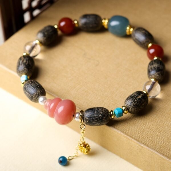 Ant-infested agarwood bracelet, 12x8mm wood beads, gemstone accented jewelry, spiritual grounding bracelet, handmade cultural mala, gold-toned charm design, natural resin patterns, ethical agarwood sourcing, elastic-free knotting, meditation prayer beads, unique charm jewelry, holistic wellness accessory, earthy aroma therapy, artisan crafted bracelet, versatile layering piece, eco-friendly materials, cultural symbolism, positive energy jewelry, gift for spiritual seekers, minimalist elegance.Temple consecration, house blessing, feng shui remedies, house pacification ceremonies, monk blessings, protective amulets, peace talismans, safety and peace assurance, wealth-invoking ceremonies, wealth deity statues, wealth-gathering formations, consecrated pi xiu (mythical creature), prayers and blessings, making vows, cultivating merit, peace and safety, imbuing objects with spiritual energy, infusing positive energy through sutra recitation, blessings, chanting mantras and dharani, liberation of deceased spirits, rebirth in the Pure Land, accumulating merit, nurturing compassion, devotional repentance, eliminating karmic obstacles, Buddha, Dharma, Sangha, portable guardian objects, peace-ensuring talismans, warding off evil spirits, neutralizing negative energies, averting disasters, deflecting misfortunes, Taiji and Bagua symbols. Buddhas: Dipamkara Buddha, Shakyamuni Buddha, Maitreya Buddha, Amitabha Buddha, Medicine Buddha, Akshobhya Buddha, Ratnasambhava Buddha, Amoghasiddhi Buddha, Five Dhyani Buddhas, Prabhutaratna Buddha. Bodhisattvas: Avalokiteshvara Bodhisattva, Manjushri Bodhisattva, Samantabhadra Bodhisattva, Ksitigarbha Bodhisattva, Mahasthamaprapta Bodhisattva, Guanyin, Wenshu, Puxian, Dizang, Maitreya, Akashagarbha, Vajrapani, Sarvanivarana-Vishkambhin.