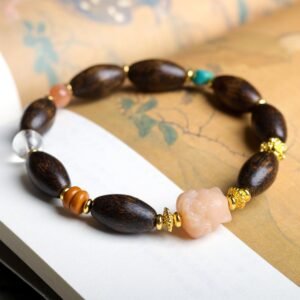 15x9mm West Malaysian agarwood bracelet, oval bead jewelry, gemstone accent bracelet, spiritual meditation bracelet, natural aroma therapy, ethical agarwood sourcing, gold-toned spacer design, handmade cultural jewelry, elastic-free knotting, holistic wellness accessory, earthy fragrance beads, versatile daily wear, artisan crafted mala, unique gift idea, eco-friendly materials, mindfulness practice tool, symbolic gemstone meanings, luxury spiritual gift, organic texture appeal, positive energy jewelry.Temple consecration, house blessing, feng shui remedies, house pacification ceremonies, monk blessings, protective amulets, peace talismans, safety and peace assurance, wealth-invoking ceremonies, wealth deity statues, wealth-gathering formations, consecrated pi xiu (mythical creature), prayers and blessings, making vows, cultivating merit, peace and safety, imbuing objects with spiritual energy, infusing positive energy through sutra recitation, blessings, chanting mantras and dharani, liberation of deceased spirits, rebirth in the Pure Land, accumulating merit, nurturing compassion, devotional repentance, eliminating karmic obstacles, Buddha, Dharma, Sangha, portable guardian objects, peace-ensuring talismans, warding off evil spirits, neutralizing negative energies, averting disasters, deflecting misfortunes, Taiji and Bagua symbols. Buddhas: Dipamkara Buddha, Shakyamuni Buddha, Maitreya Buddha, Amitabha Buddha, Medicine Buddha, Akshobhya Buddha, Ratnasambhava Buddha, Amoghasiddhi Buddha, Five Dhyani Buddhas, Prabhutaratna Buddha. Bodhisattvas: Avalokiteshvara Bodhisattva, Manjushri Bodhisattva, Samantabhadra Bodhisattva, Ksitigarbha Bodhisattva, Mahasthamaprapta Bodhisattva, Guanyin, Wenshu, Puxian, Dizang, Maitreya, Akashagarbha, Vajrapani, Sarvanivarana-Vishkambhin.