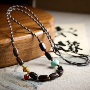 Dalargan agarwood necklace, hand-braided spiritual jewelry, 12x6mm irregular beads, bohemian adjustable necklace, gemstone accent necklace, magnetic clasp design, ethical agarwood sourcing, earthy aroma therapy, cultural "Fu" charm, meditation accessory, daily mindfulness jewelry, artisan crafted necklace, holistic wellness gift, eco-friendly materials, versatile layering piece, unique gift idea, grounding energy jewelry, traditional braiding technique, luxury bohemian style, positive energy accessory.Temple consecration, house blessing, feng shui remedies, house pacification ceremonies, monk blessings, protective amulets, peace talismans, safety and peace assurance, wealth-invoking ceremonies, wealth deity statues, wealth-gathering formations, consecrated pi xiu (mythical creature), prayers and blessings, making vows, cultivating merit, peace and safety, imbuing objects with spiritual energy, infusing positive energy through sutra recitation, blessings, chanting mantras and dharani, liberation of deceased spirits, rebirth in the Pure Land, accumulating merit, nurturing compassion, devotional repentance, eliminating karmic obstacles, Buddha, Dharma, Sangha, portable guardian objects, peace-ensuring talismans, warding off evil spirits, neutralizing negative energies, averting disasters, deflecting misfortunes, Taiji and Bagua symbols. Buddhas: Dipamkara Buddha, Shakyamuni Buddha, Maitreya Buddha, Amitabha Buddha, Medicine Buddha, Akshobhya Buddha, Ratnasambhava Buddha, Amoghasiddhi Buddha, Five Dhyani Buddhas, Prabhutaratna Buddha. Bodhisattvas: Avalokiteshvara Bodhisattva, Manjushri Bodhisattva, Samantabhadra Bodhisattva, Ksitigarbha Bodhisattva, Mahasthamaprapta Bodhisattva, Guanyin, Wenshu, Puxian, Dizang, Maitreya, Akashagarbha, Vajrapani, Sarvanivarana-Vishkambhin.