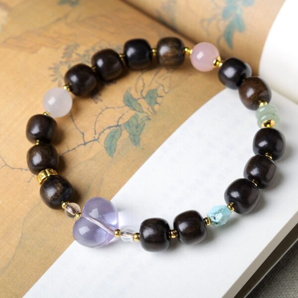 8-9mm medicinal agarwood bracelet, peach-shaped amethyst jewelry, healing crystal bracelet, spiritual grounding accessory, cultural symbolism bracelet, handmade gemstone beads, gold-toned spacer design, natural aroma therapy, ethical sourcing, holistic wellness gift, playful elegance bracelet, positive energy jewelry, mindfulness meditation accessory, elastic-free knotting, unique gift idea, eco-friendly materials, artisan crafted, versatile layering piece, Eastern-inspired design, emotional balance jewelry.Temple consecration, house blessing, feng shui remedies, house pacification ceremonies, monk blessings, protective amulets, peace talismans, safety and peace assurance, wealth-invoking ceremonies, wealth deity statues, wealth-gathering formations, consecrated pi xiu (mythical creature), prayers and blessings, making vows, cultivating merit, peace and safety, imbuing objects with spiritual energy, infusing positive energy through sutra recitation, blessings, chanting mantras and dharani, liberation of deceased spirits, rebirth in the Pure Land, accumulating merit, nurturing compassion, devotional repentance, eliminating karmic obstacles, Buddha, Dharma, Sangha, portable guardian objects, peace-ensuring talismans, warding off evil spirits, neutralizing negative energies, averting disasters, deflecting misfortunes, Taiji and Bagua symbols. Buddhas: Dipamkara Buddha, Shakyamuni Buddha, Maitreya Buddha, Amitabha Buddha, Medicine Buddha, Akshobhya Buddha, Ratnasambhava Buddha, Amoghasiddhi Buddha, Five Dhyani Buddhas, Prabhutaratna Buddha. Bodhisattvas: Avalokiteshvara Bodhisattva, Manjushri Bodhisattva, Samantabhadra Bodhisattva, Ksitigarbha Bodhisattva, Mahasthamaprapta Bodhisattva, Guanyin, Wenshu, Puxian, Dizang, Maitreya, Akashagarbha, Vajrapani, Sarvanivarana-Vishkambhin.
