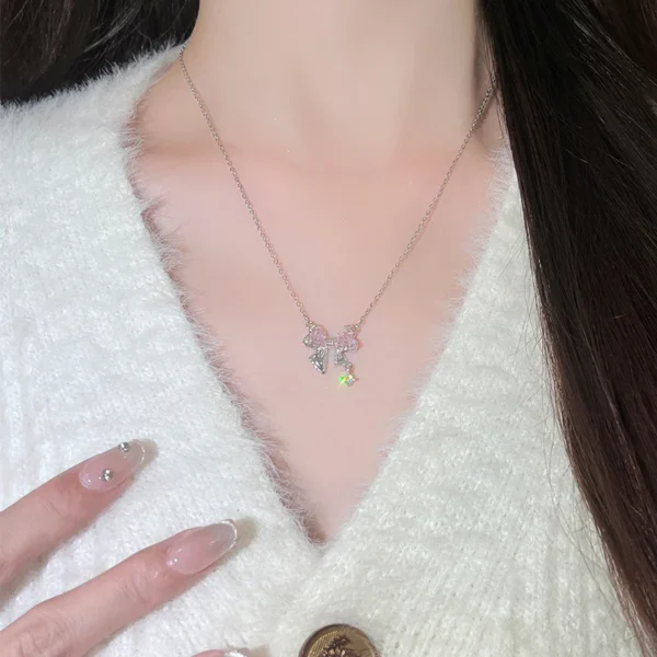Titanium steel bow necklace, pink zircon necklace, light luxury collarbone chain, women's delicate jewelry, adjustable chain necklace, hypoallergenic fashion accessory, silver-toned jewelry, feminine gift idea, JUSONG KLEIN brand, sustainable materials, artisan crafted, versatile daily wear, cubic zirconia accents, affordable luxury, modern minimalist style, positive energy accessory, cultural inspired design, holistic wellness jewelry, unique niche jewelry, special occasion gift.