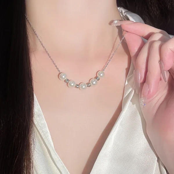 Titanium steel imitation pearl necklace, 5-pearl collarbone chain, light luxury jewelry for women, minimalist necklace with crystals, adjustable chain necklace, white gold-toned accessory, hypoallergenic fashion jewelry, niche design necklace, elegant everyday wear, sustainable materials, affordable luxury, crystal-accented pendant, versatile daily necklace, gift for her, modern minimalist style, artisan crafted, positive energy accessory, cultural inspired design, holistic wellness jewelry, timeless charm necklace.