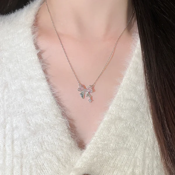 Titanium steel bow necklace, pink zircon necklace, light luxury collarbone chain, women's delicate jewelry, adjustable chain necklace, hypoallergenic fashion accessory, silver-toned jewelry, feminine gift idea, JUSONG KLEIN brand, sustainable materials, artisan crafted, versatile daily wear, cubic zirconia accents, affordable luxury, modern minimalist style, positive energy accessory, cultural inspired design, holistic wellness jewelry, unique niche jewelry, special occasion gift.