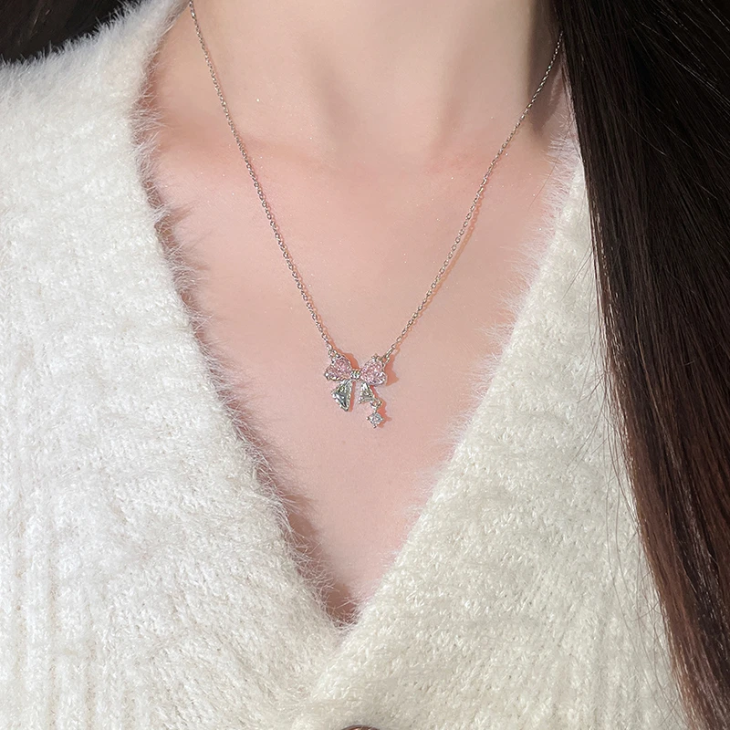 Titanium steel bow necklace, pink zircon necklace, light luxury collarbone chain, women's delicate jewelry, adjustable chain necklace, hypoallergenic fashion accessory, silver-toned jewelry, feminine gift idea, JUSONG KLEIN brand, sustainable materials, artisan crafted, versatile daily wear, cubic zirconia accents, affordable luxury, modern minimalist style, positive energy accessory, cultural inspired design, holistic wellness jewelry, unique niche jewelry, special occasion gift.