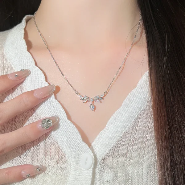 Titanium steel laurel flower necklace, minimalist lucky necklace, women's floral collarbone chain, pearl and crystal accent jewelry, adjustable light luxury necklace, white gold-toned accessory, hypoallergenic fashion jewelry, symbolic victory necklace, versatile daily wear, gift for her, sustainable materials, affordable luxury, artisan crafted, positive energy accessory, cultural inspired design, holistic wellness jewelry, timeless elegance, niche fashion necklace, modern minimalist style.