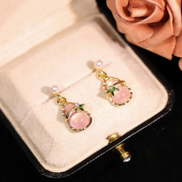 Ludeng copper-alloy earrings, light luxury pink stone earrings, teardrop design earrings, pearl accent jewelry, versatile fashion earrings, hypoallergenic gold-toned earrings, elegant daily wear earrings, gift for her, affordable luxury accessories, nickel-free earrings, tarnish-resistant jewelry, secure clutch earrings, feminine elegance earrings, nature-inspired accents, wardrobe staple earrings, sophisticated pearl details, casual to formal earrings, artistic jewelry design, modern classic earrings.