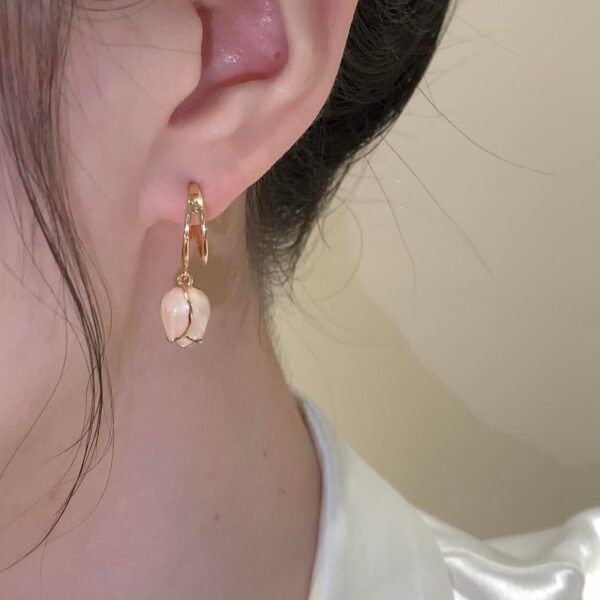 Copper alloy blooming buds earrings, floral pearl drop earrings, lightweight hoop earrings, minimalist gold-tone jewelry, hypoallergenic earrings for women, simulated pearl elegance, versatile daily wear earrings, luxury gift box jewelry, affordable light luxury, nickel-free fashion earrings, tarnish-resistant design, stacking earrings, bohemian chic accessories, sustainable materials, sensitive ears safe, artistic craftsmanship, modern classic earrings, holistic wellness accessory, unique design earrings, seasonal spring jewelry.