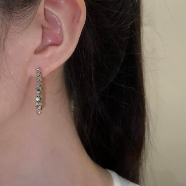 Copper alloy dreamland earrings, light luxury crystal earrings, hypoallergenic fashion earrings, versatile hoop and drop stud designs, silver black crystal accents, elegant niche jewelry, women's daily wear earrings, gift box earrings, affordable luxury accessories, nickel-free earrings, tarnish-resistant jewelry, dreamy aesthetic earrings, geometric pattern earrings, minimalist yet glamorous, sustainable materials, bohemian chic style, holistic wellness accessory, unique design earrings, special occasion gifts, artistic craftsmanship.