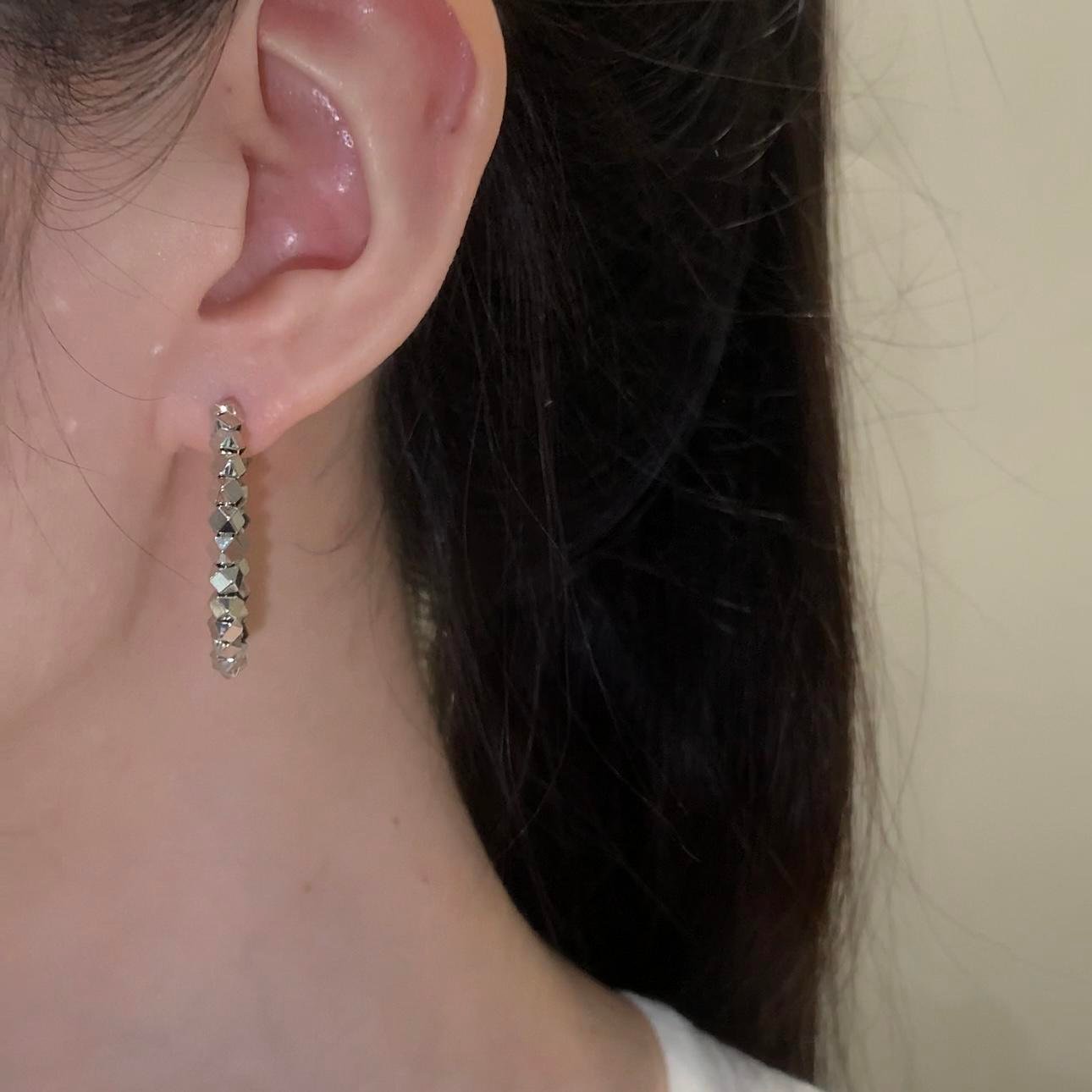 Copper alloy dreamland earrings, light luxury crystal earrings, hypoallergenic fashion earrings, versatile hoop and drop stud designs, silver black crystal accents, elegant niche jewelry, women's daily wear earrings, gift box earrings, affordable luxury accessories, nickel-free earrings, tarnish-resistant jewelry, dreamy aesthetic earrings, geometric pattern earrings, minimalist yet glamorous, sustainable materials, bohemian chic style, holistic wellness accessory, unique design earrings, special occasion gifts, artistic craftsmanship.