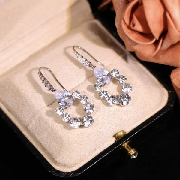 Starlight copper-alloy earrings, celestial crystal jewelry, light luxury fashion earrings, versatile niche design, hypoallergenic silver-toned earrings, sparkling star-inspired accessories, unique gift idea, artistic handmade earrings, daily elegance jewelry, special occasion earrings, affordable luxury accessories, nickel-free earrings, tarnish-resistant design, celestial motif jewelry, bohemian chic style, minimalist yet glamorous, women's fashion gifts, holistic wellness accessory, cosmic-inspired elegance, sustainable materials.