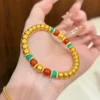 Gold Pumpkin Bead Bracelet with Red Blue Beads on Hand with Ring