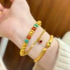 Layered Look with Gold Pumpkin Bead Bracelet, Heart Chain, and Snake Bangle