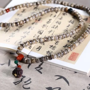 Blood Vein Moon Bodhi Bracelet with Awakening Lion Charm on Calligraphy Paper