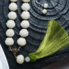 White Jade Bodhi Lotus Mala with Green Tassel on Dark Background