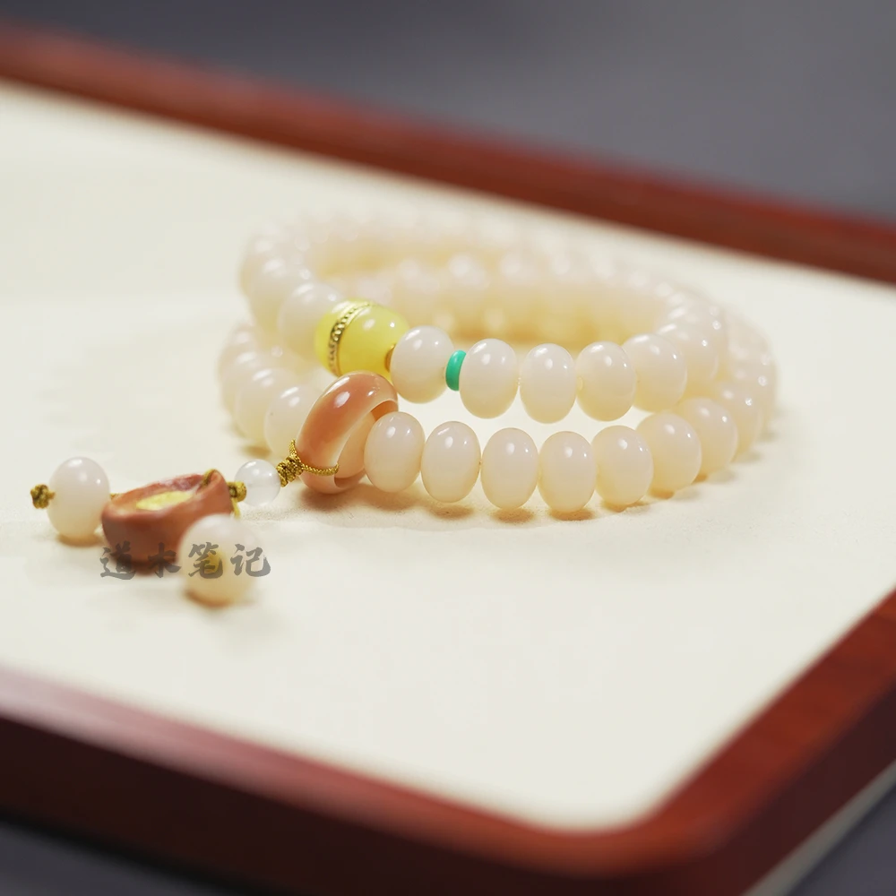 White Jade Bodhi Handheld Mala with Multi-Color Beads on Wooden Surface