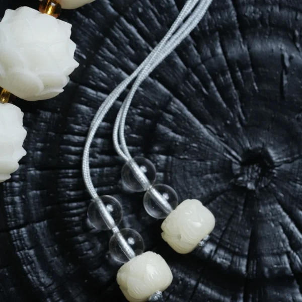 Close-up of Lotus-shaped White Jade Bodhi Beads with Gold Spacers